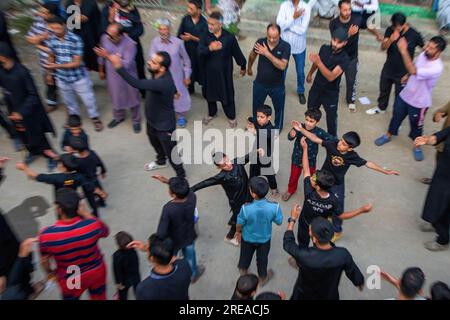 Srinagar, India. 25 luglio 2023. I bambini musulmani sciiti del Kashmir picchiarono il loro petto durante la processione di lutto il 7° giorno di Muharram nella periferia di Srinagar. Ashura segna il martirio dell'Imam Hussain, nipote del profeta Mohammed e dei suoi familiari più stretti che furono uccisi nella battaglia di Karbala nell'Iraq meridionale nel 680 d.C.. (Foto di Faisal Bashir/SOPA Images/Sipa USA) credito: SIPA USA/Alamy Live News Foto Stock