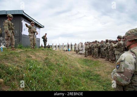 19 luglio 2023 - Polonia - Stati Uniti Army Sgt. 1st Class Thomas Danies with Alpha Company, 1st Battalion, 9th Cavalry Regiment, 2nd Armored Brigade Combat Team, 1st Cavalry Division, Supporting 4th Infantry Division, briefs U.S. Soldati dell'esercito e soldati dell'esercito polacco con Polands Territorial Defense Force, durante l'addestramento tedesco per la qualificazione alle armi presso Bemowo Piskie Training area, Polonia, 18 luglio. Questo faceva parte di un addestramento tedesco per la qualificazione delle armi tenuto dai membri del Enhanced Forward Presence Battle Group Poland della NATO. I soldati parteciparono all'addestramento al fine di guadagnare il tedesco Armed for Foto Stock