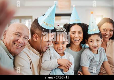 Selfie di compleanno, famiglia numerosa o bambini felici con nonni che scattano foto in salotto in casa. Ritratto di volti, madre o padre con sorriso o. Foto Stock