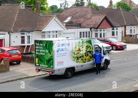 Un furgone elettrico Tesco per la consegna a domicilio parcheggiato in una strada periferica, Shepperton Surrey Inghilterra Regno Unito Foto Stock