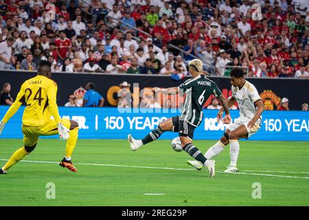 Il centrocampista del Real Madrid Jude Bellingham (5) segna un gol contro il difensore del Manchester United Lisandro Martínez (6) e il portiere Andre Onana (24) Foto Stock