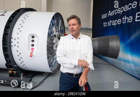 Ottobrunn, Germania. 28 luglio 2023. Il ministro dell'economia tedesco Robert Habeck (Bündnis 90/Die Grünen) passeggia davanti a un prototipo di razzo durante una visita alla società spaziale Isar Aerospace. Crediti: Marijan Murat/dpa/Alamy Live News Foto Stock