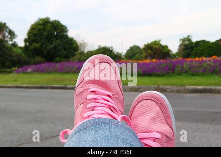 Scarpe da ginnastica rosa rilassanti in giardino Foto Stock