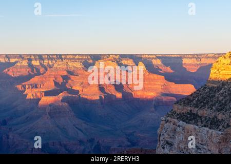 Il caldo sorgere del sole sulla vastità del Grand Canyon. Foto Stock