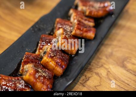 Sliced Unagi. Anguilla grigliata con salsa servita sul piatto Foto Stock