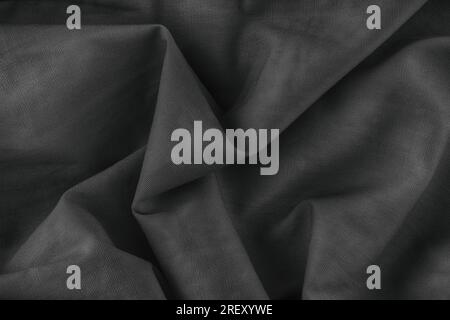 Folded fabric texture background. Black and white. Close up. Stock Photo