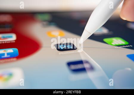 Bangkok, Thailandia - 30 luglio 2023: Utente iPad che tocca un'icona di Adobe Photoshop per aprire l'applicazione. Foto Stock