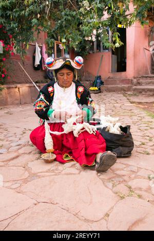 Llachon, Perù; 1 gennaio 2023: Una donna che lavora con la lana nella penisola di Llachon sul lago Titicaca. Foto Stock