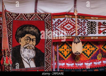 Kazakistan, Saty. Decorazioni interne yurta. Poeta kazako Zhambyl Zhabayev mostrato sulla decorazione del tappeto. Foto Stock