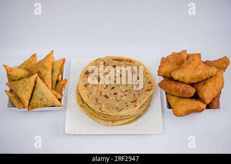 Chapati Mandazi Andazi Samosa spuntini triangolari su un piatto su sfondo bianco nella città di Nairobi, nella contea del Kenya, nell'Africa orientale. Cibo delizioso Foto Stock