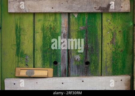 Tavole in legno verde, struttura ruvida, porta con serratura Foto Stock