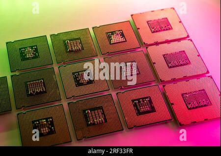 Raccolta di processori per computer (CPU) illuminati in verde e rosso su una superficie luminosa Foto Stock