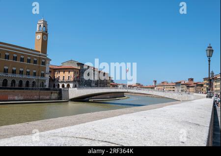 Skyline di Pisa sul fiume amo che scorre attraverso la città sotto il Ponte di mezzo e l'edificio con una torre è Palazzo Pretori Foto Stock