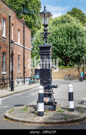 Una pompa dell'acqua pubblica georgiana di grado II a Bedford Row, Holborn, Londra, Regno Unito. Costruita nel 1826, la pompa è dotata di due beccucci Foto Stock