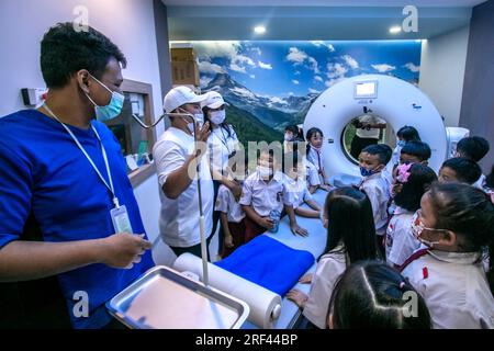 Gli studenti delle scuole elementari a Bogor City, Indonesia, vedono una sala di scansione TC durante un tour dell'ospedale Vania Bogor Foto Stock