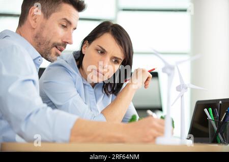 architetti che studiano i piani in un ufficio moderno insieme Foto Stock