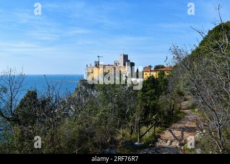 Vista del Castello di Duino e del sentiero che conduce attraverso la riserva naturale delle Falesie di Duino in Friuli Venezia Giulia Foto Stock