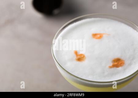 Pisco Sour cocktail pisco fatto in casa, succo di limone fresco, sciroppo, albume d'uovo e amari aromatici Foto Stock