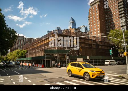 Edificio commerciale vuoto coperto da impalcature e un capannone per marciapiedi, che in precedenza ospitava un McDonald's, un supermercato Gristedes, un centro tennis e alcune piccole imprese, a Chelsea a New York venerdì 28 luglio 2023. L'edificio, di proprietà della cooperativa Mutual ReDevelopment Housing, ha raggiunto la fine della sua vita ed è in procinto di scendere, per essere sostituito da alloggi. (© Richard B. Levine) Foto Stock