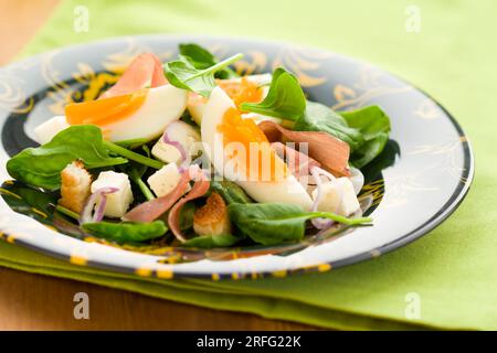 insalata primaverile con spinaci, uova, prosciutto e feta Foto Stock