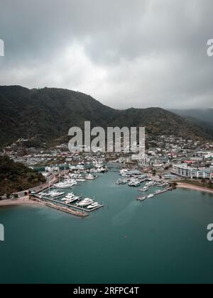 Un colpo di drone scattato sopra l'oceano guardando indietro verso la terraferma di Picton's Marina in nuova Zelanda Foto Stock
