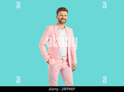 Felice uomo d'affari barbuto di successo che indossa un abito rosa pastello Foto Stock