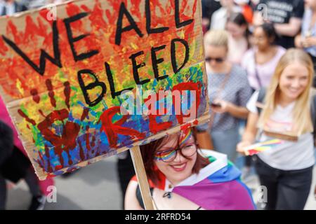 Norimberga, Germania. 5 agosto 2023. "We All Bleed RED" è scritto sul segno di un partecipante a una dimostrazione CSD durante la Norimberga Prideweek. Con il motto "Queerer Aktionsplan Bayern jetzt!” diverse migliaia di partecipanti hanno dimostrato per la diversità e l'uguaglianza. Credito: Daniel Karmann/dpa/Alamy Live News Foto Stock