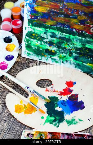 il processo creativo di disegno mescolando diversi colori delle vernici con pennelli artistici, pennelli artistici e vernici per quadri, olio e altri pai Foto Stock