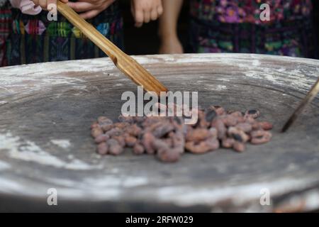 Fagioli di cacao crudi arrostiti su tradizionale griglia di argilla comal in Guatemala Foto Stock