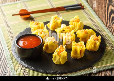 Lo shumai è un tipo di gnocchi tradizionali cinesi pieni di gamberi o granchi, primo piano dim sum sul tavolo. Orizzontale Foto Stock