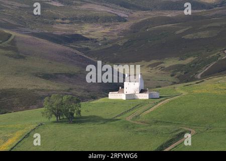 Castello di Corgarff nel Cairngorms National Park nell'Aberdeenshire, su una collina accanto a Moorland al sole di prima mattina Foto Stock