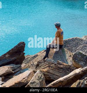 Turisti maschi e escursionisti che guardano il lago Moraine durante l'escursione a Banff, Alberta, Canada. Foto Stock