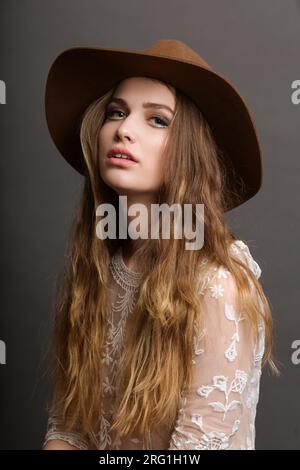 Ritratto di una giovane donna dai capelli lunghi che indossa un cappello Foto Stock