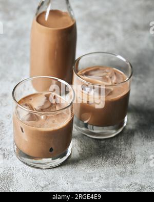 Due bicchieri di Irish Cream con ghiaccio e bottiglia Foto Stock