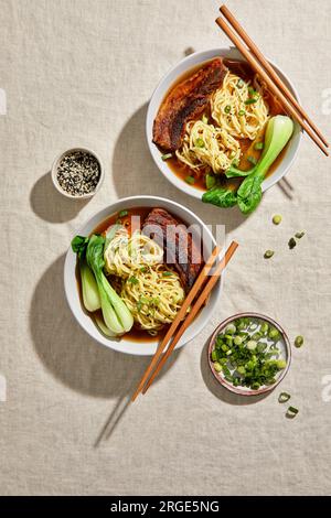 Ramen, Pork Belly e Bok Choy con sfondo neutro chiaro Foto Stock