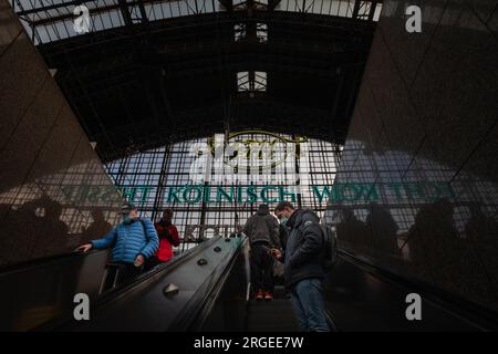 Immagine di un uomo in attesa di un treno sulle piattaforme della stazione ferroviaria di Colonia Koln hauptbahnhof, indossando maschere facciali durante il Coronavirus Covid 19 h. Foto Stock
