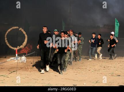 Gaza, Palestina. 8 agosto 2023. I giovani palestinesi partecipano a un campo estivo militare organizzato dalle Brigate al-Qassam, l'ala militare di Hamas, a Khan Yunis, nella Striscia di Gaza meridionale. (Foto di Yousef Masoud/SOPA Images/Sipa USA) credito: SIPA USA/Alamy Live News Foto Stock