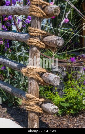Recinzione da giardino fatta di pali e corde di legno Foto Stock