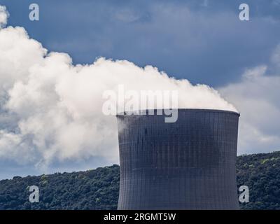 Cruas, Francia - 4 aprile 2023: Vista sul fiume sulla centrale nucleare (CNPE Cruas-Meysse) sullo sfondo di rocce calcaree. Foto Stock