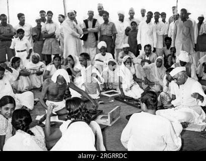 New Delhi, India: 19 aprile 1946 Mahatma Gandhi e Pandit Jawaharlal Nehru partecipano a una manifestazione "charkha" tenutasi nella colonia di Bhangi a nuova Delhi in occasione dell'inaugurazione della settimana Nazionale. Il charkha era sia un attrezzo per ruota che girava che un simbolo del movimento per l'indipendenza indiana. Foto Stock