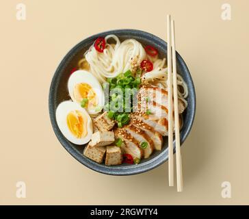 ciotola di zuppa di noodle asiatico ramen con uova e pollo, vista dall'alto Foto Stock
