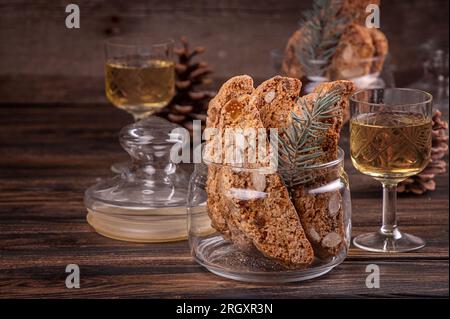 Italiano tradizionale di Natale Capodanno biscotti secchi biscotti biscotti cantuccini in recipiente di vetro su sfondo di legno. Biscotti di Prato. Foto Stock