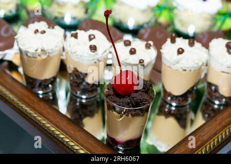 Eventi sociali; presentazione individuale di dessert per gli ospiti alla reception Foto Stock