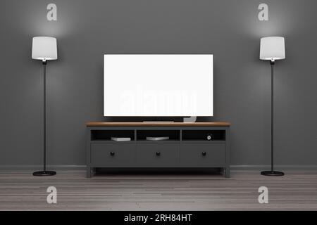 Un televisore con schermo bianco vuoto si trova su un piedistallo del televisore. Mobili per la TV. TV mockup in una stanza buia. Sala TV. Rendering 3D. Foto Stock