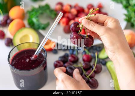 Ciliegie e altri tipi di frutta e verdura, preparazione di frullati. Foto Stock