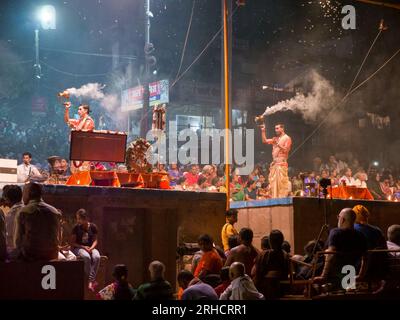 Varanasi, India - 11 novembre 2015. Sacerdoti indù che eseguono una cerimonia devozionale nota come Ganga Aarti di fronte agli spettatori accanto al Gange. Foto Stock