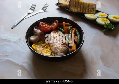 Close up of grilled chicken fillet served with veggies in a bowl. Stock Photo