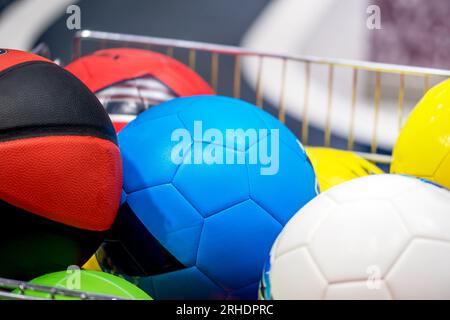 Calcio e pallavolo nel carrello del negozio di articoli sportivi. Negozi di attrezzature sportive Foto Stock