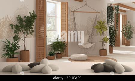 Tavolo bianco, scrivania o ripiano con cinque morbidi cuscini bianchi a forma di stelle o fiori, salotto astinente con sedia sospesa in pizzo di rattan, con cui Foto Stock