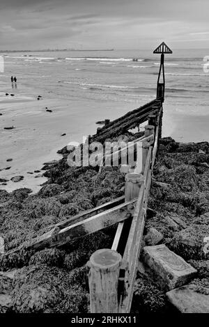 Vecchio posto di navigazione all'ingresso del porto di Seaton, durante un pomeriggio buio Foto Stock